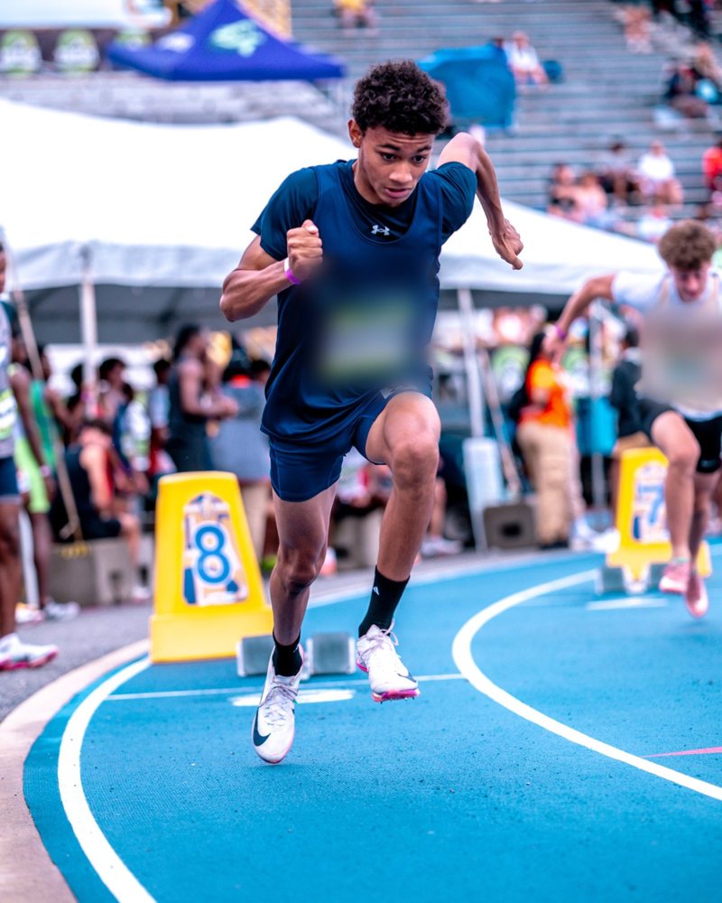 A sprinter driving out of the starting blocks